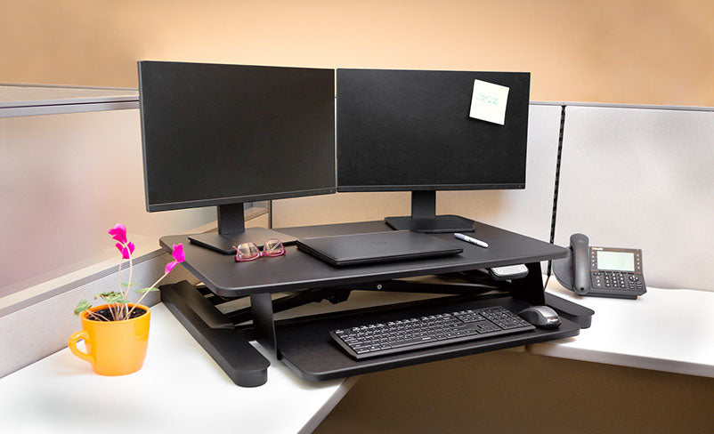 THE FREEDOM E-DESK DESKTOP CONVERTER FITS DUAL 24IN MONITORS AND SUPPORTS UP TO